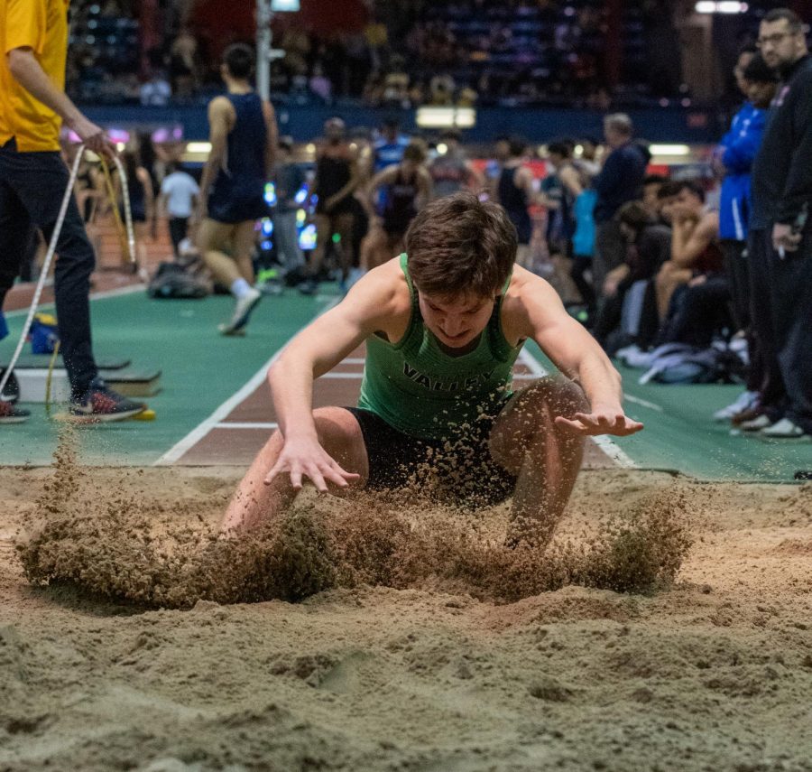 Senior Joe Mercurio attempts to stick the landing in the long jump pit. The winter track team looks to have similar success to last year, when its Sprint Medley Relay reached the New Balance Nationals.