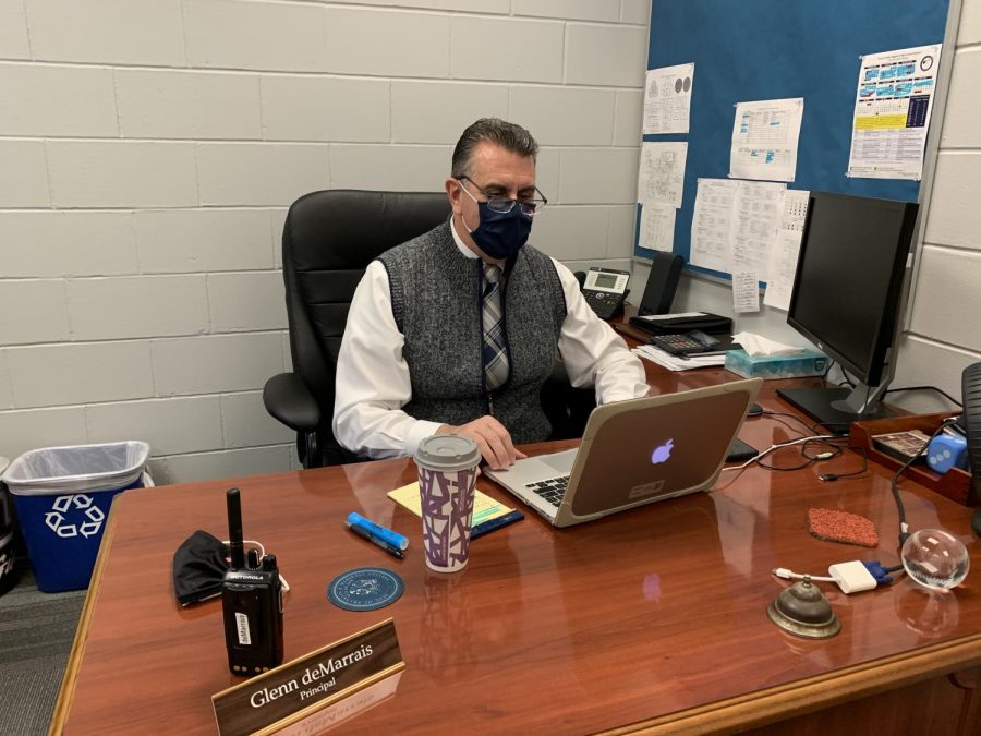 The 2020-2021 interim principal Glenn deMarrais sitting in his office.