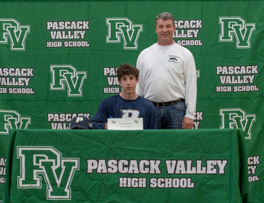 Senior Mason Baronian and coach Will Lynch participate in a signing ceremony for college-bound athletes. Baronian will be continuing his academic and athletic careers at Pace University.