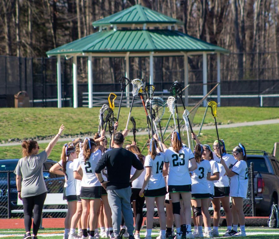 The girls lacrosse team huddles together. They are 8-6 after this week, looking to make a push for a higher seed in the state tournament. 