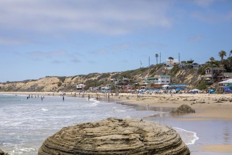 People crowding onto Crystal Cove beach