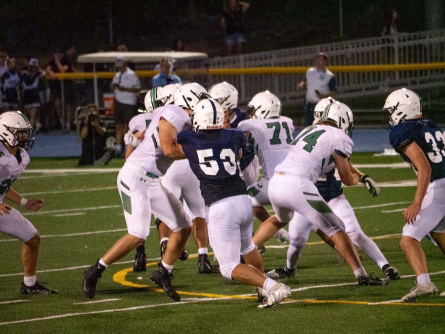 The Pascack Valley offensive line works hard to protect the quarterback. The Panthers lost a close game to Paramus in double overtime.