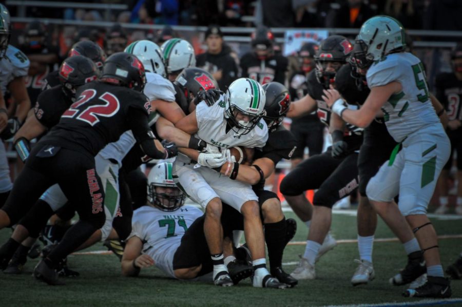 Danny Kastanis tries to push himself forward as a swarm of Highlands defenders attempt to take him down.