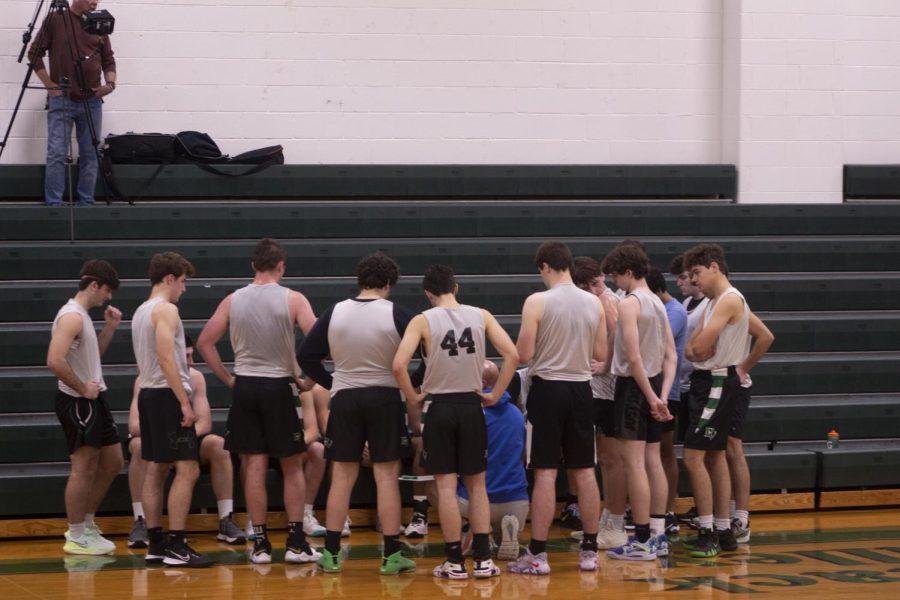The boys basketball team huddles up in their scrimmage against St. Joes (Mont.) The senior leaders look to will this years boys basketball team to success.