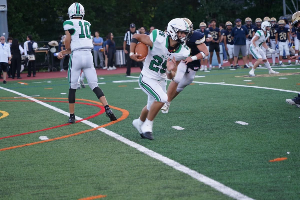 Kevin Regula turns up-field in the football teams game against Old Tappan. He is Septembers male athlete of the month.