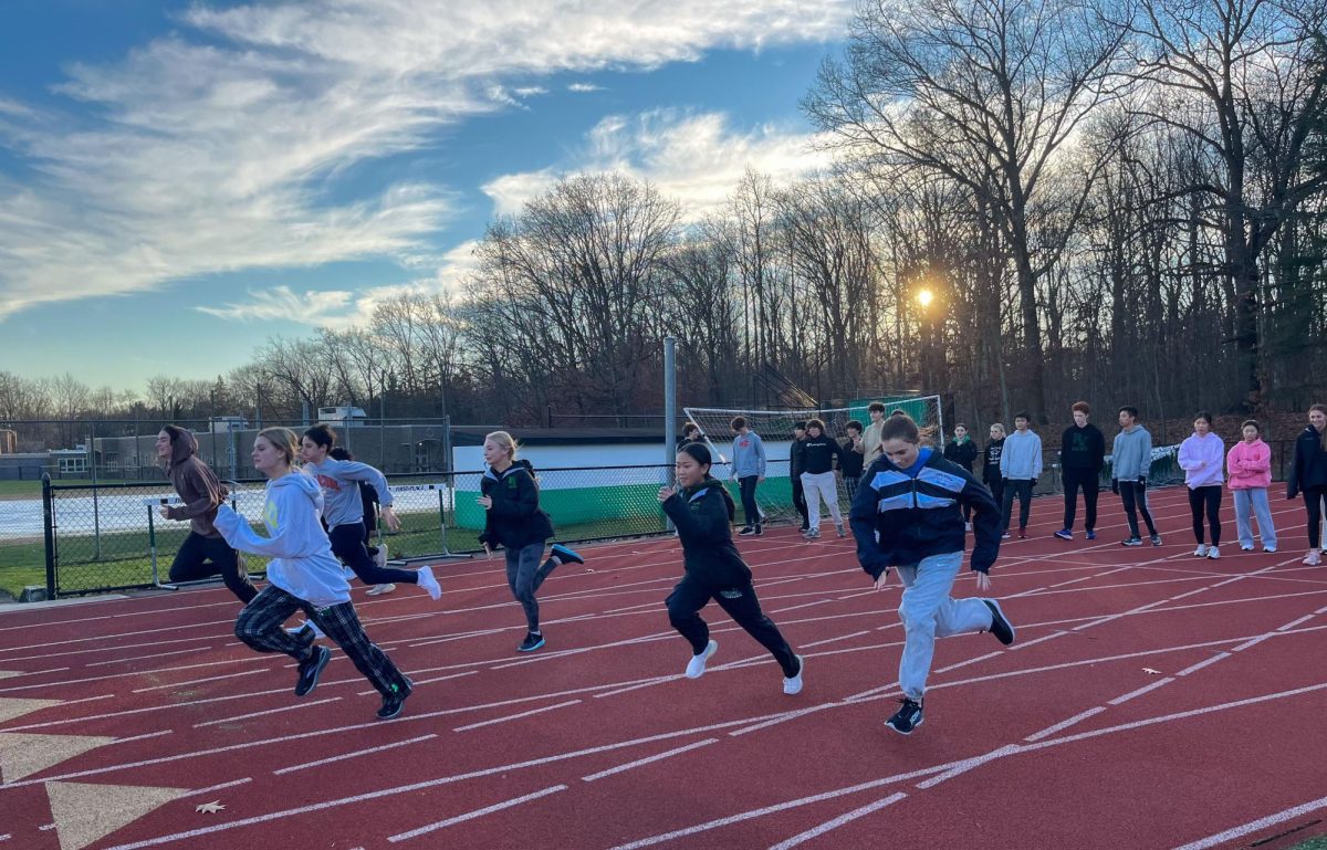 The winter track team warms up during practice. The team will lean on returners for success this year.