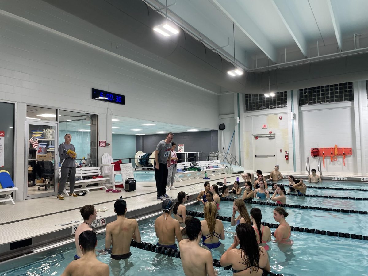 Coach Shawn Buchanan addresses his team during a practice. The swim & dive team looks to succeed with their young, energetic talent, while being complimented by strong leadership. 