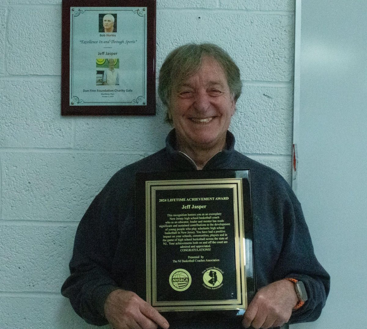 Coach Jeff Jasper poses with the Lifetime Achievement plaque.