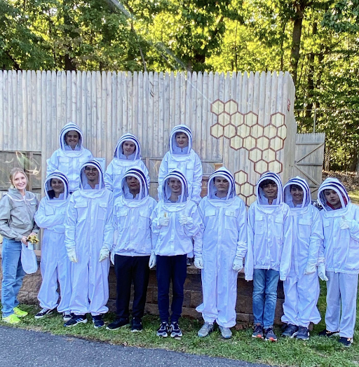 Members of the Pascack Valley Beekeeping Club stands in front of the hive. 