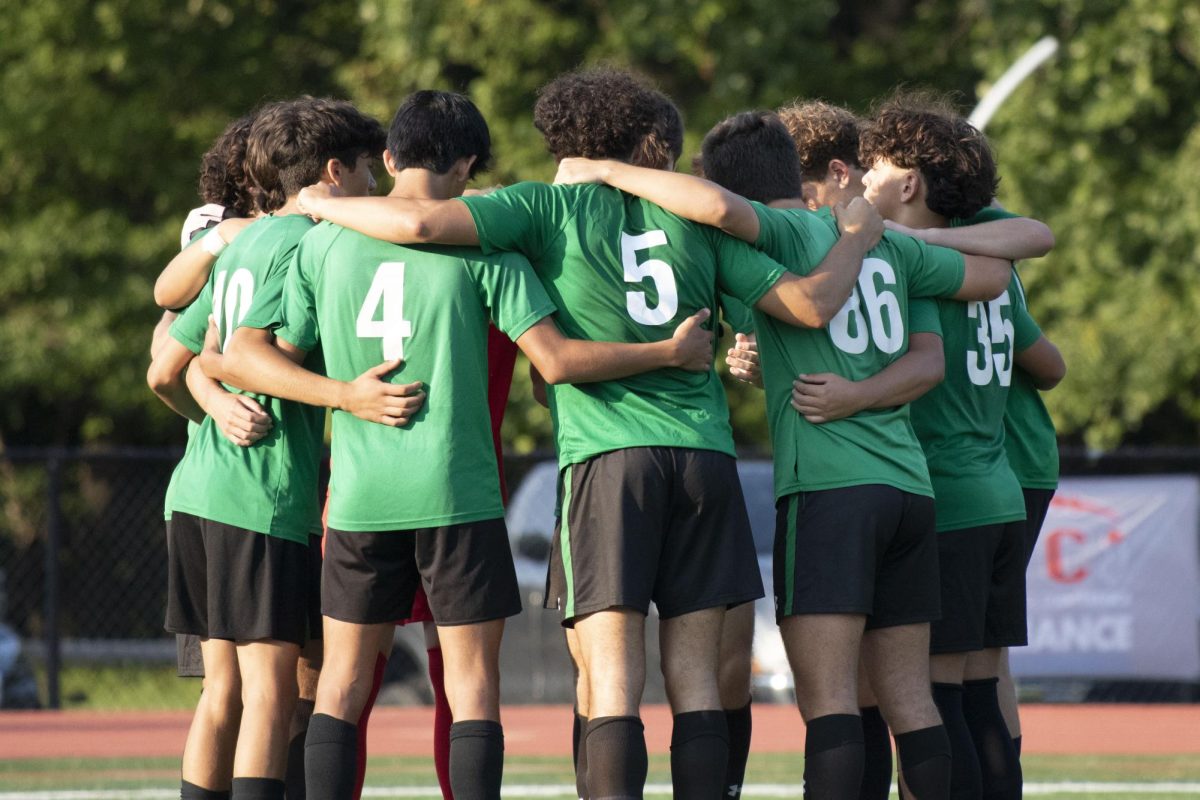 Boys soccer huddles up.