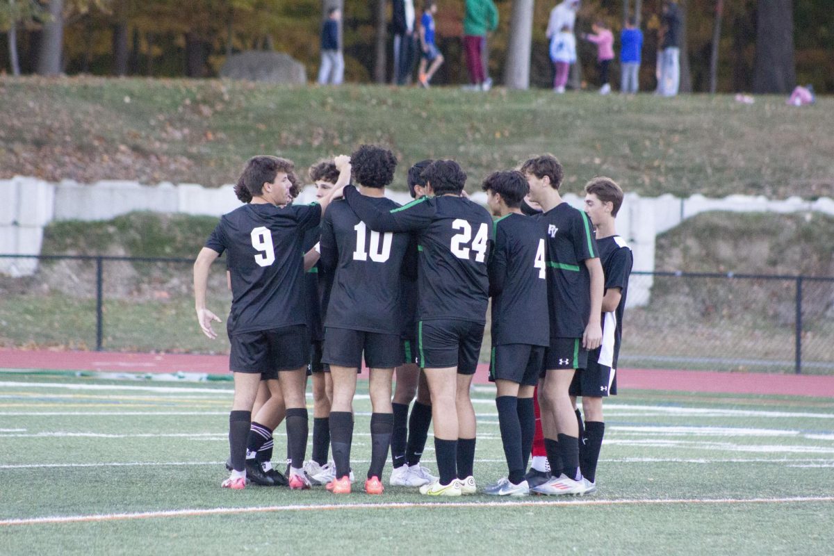 The Pascack Valley Boys Soccer Team huddles up during its home game against North Arlington.