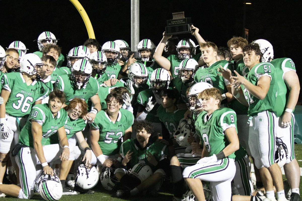 Pascack Valley hoists the Rumble for the Rail trophy after their 35-7 win against River Dell on Oct. 18, 2024 