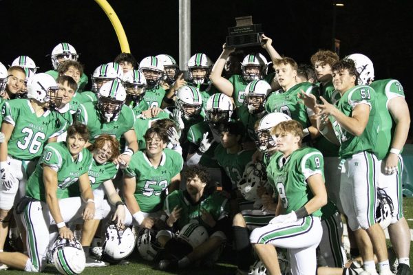 Pascack Valley hoists the Rumble for the Rail trophy after their 35-7 win against River Dell on Oct. 18, 2024 