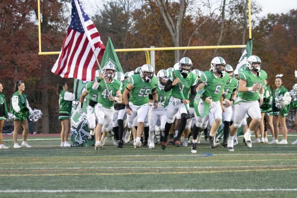 Valley Football runs onto the field before its game against NVOT