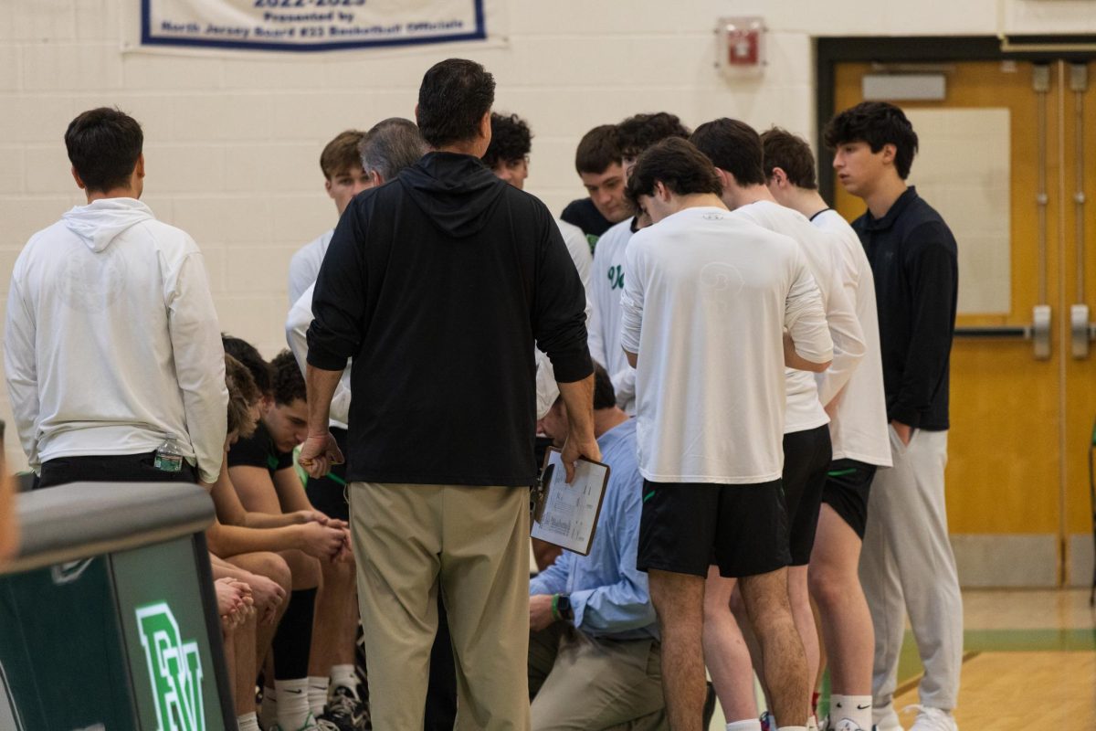 The Boys Basketball Team huddles up before its game against Tenalfy