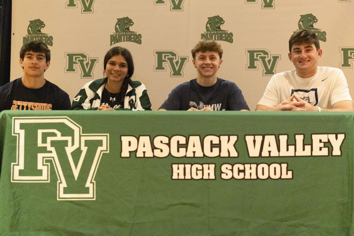Ell Road athletes Kevin Regula, Celina Bussanich, Dylan Borges, and Trevor Kirkby together on signing day