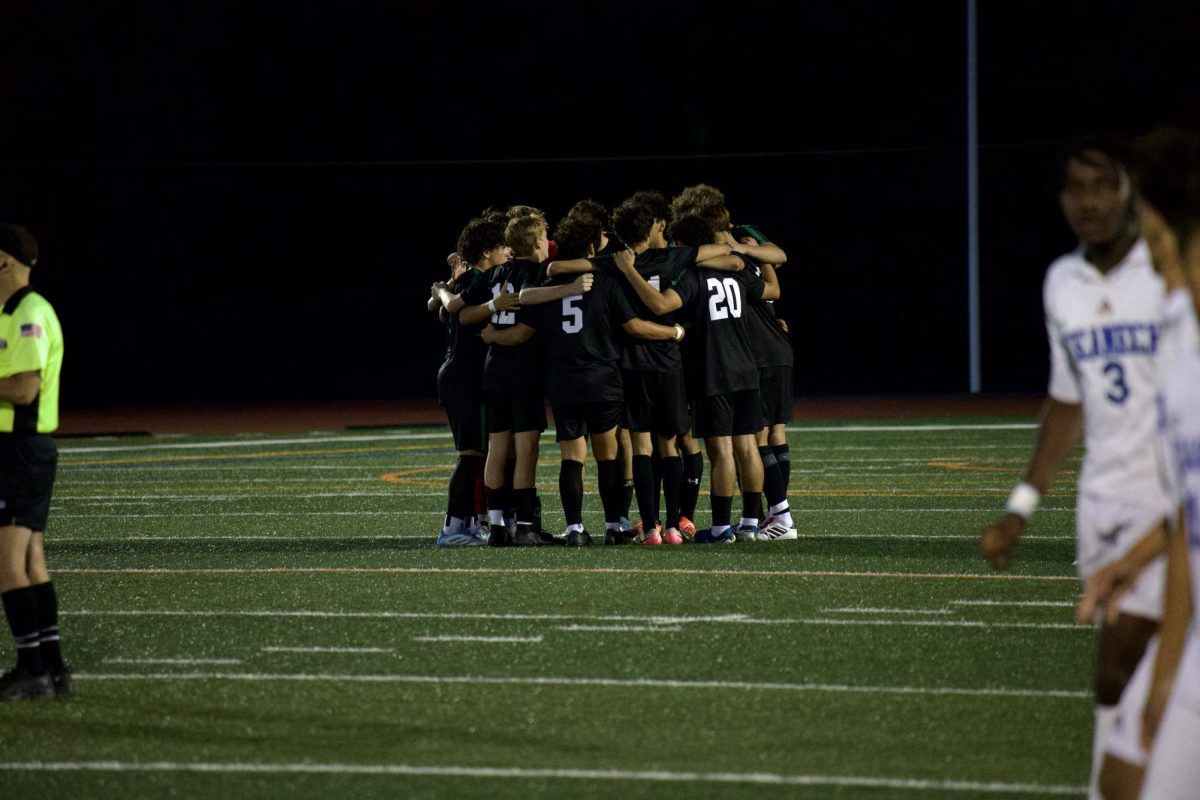 Boys soccer huddles in game against Teaneck on Sept. 4