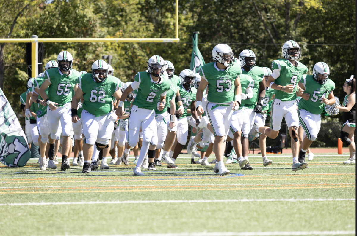Valley football runs out onto the field before their game against Northern Highlands
