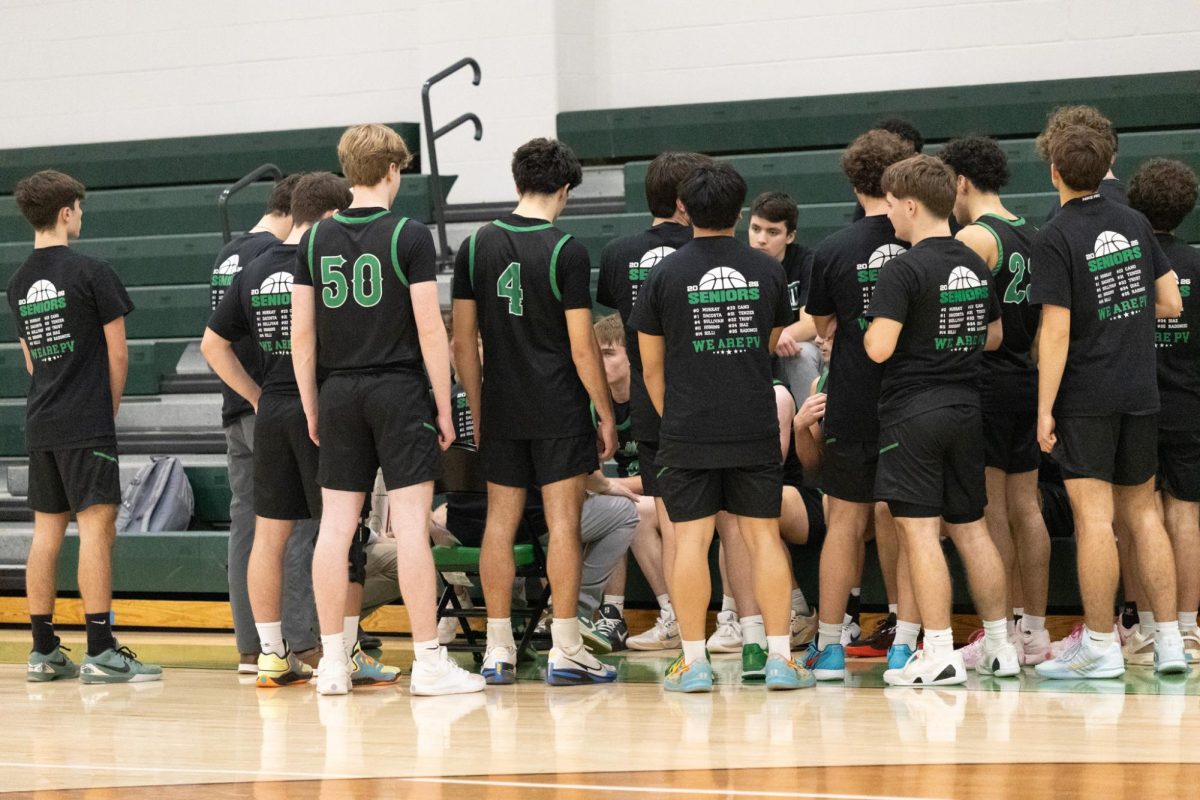 Boys Basketball team huddles up during a timeout