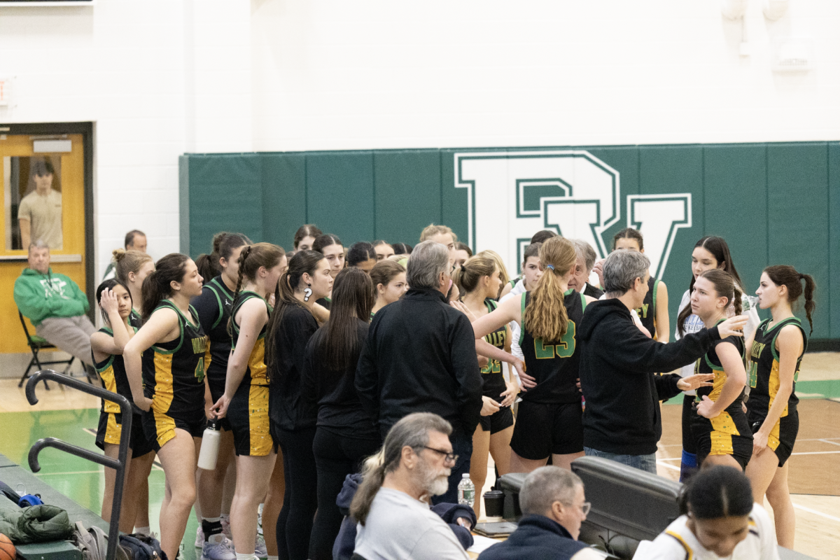 Pascack Valley girls basketball team huddled up during a timeout